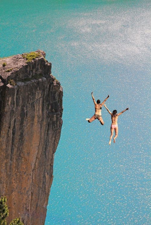 Couple Jumping off a Cliff