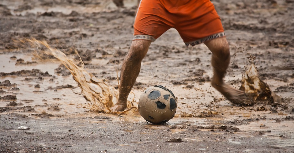 Playing Footbal In Mud