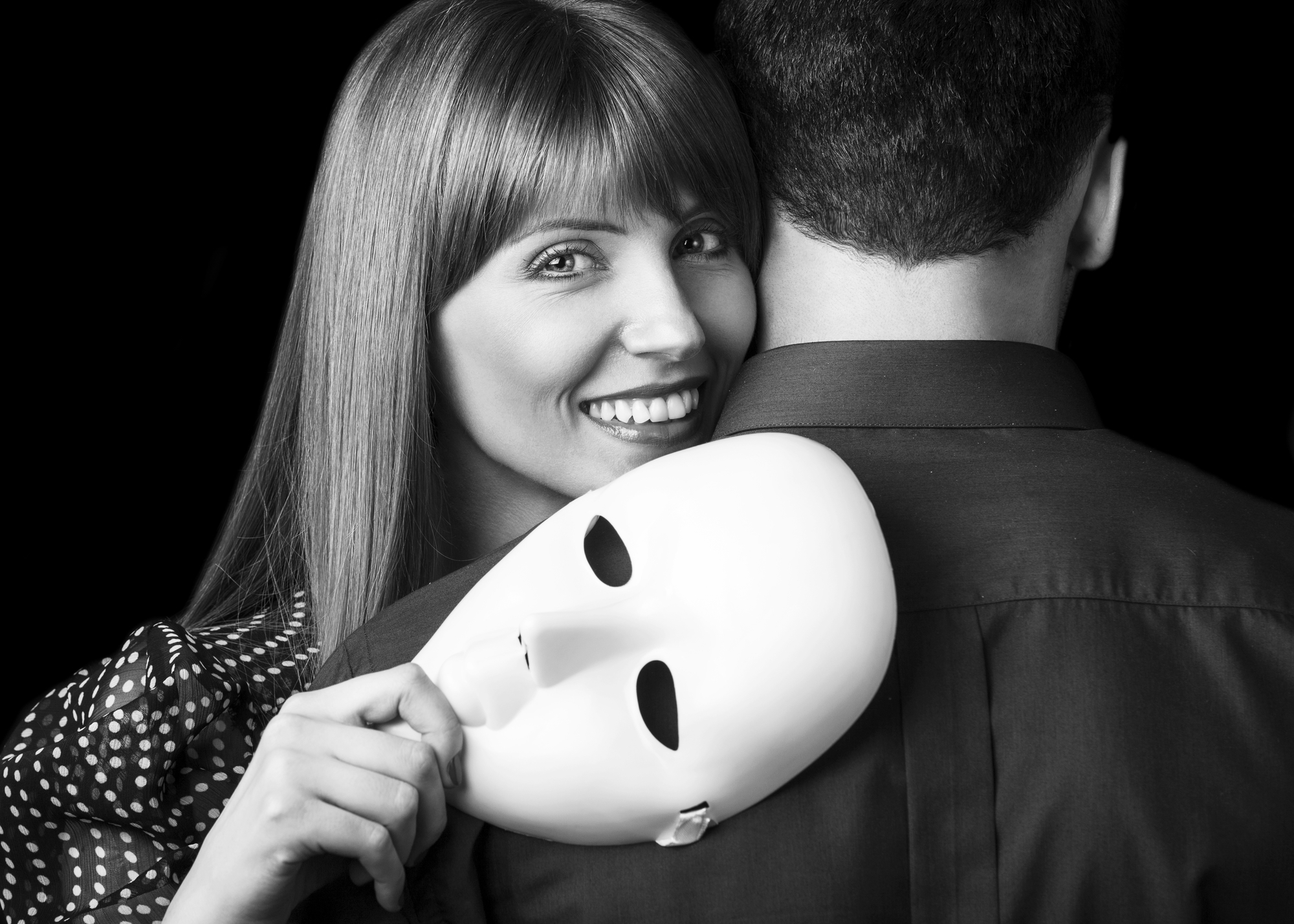 Fashion Happy Couple in Love holding a white mask face. Psycholo